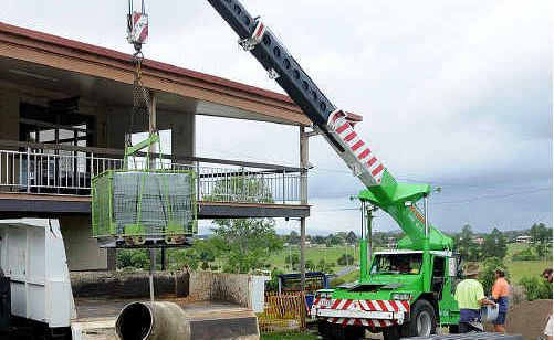 A Kelly Green crane lifts another load of blocks at the Gympie Hockey Centre. A Kelly Green crane lifts another load of blocks at the Gympie Hockey Centre.